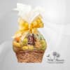 Fruit basket wrapped in clear cellophane with a gold bow