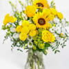 Yellow and white mixed bouquet in a clear glass vase