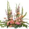 Pink and peach floral arrangement with tall green spikes and orange daisies