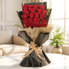 Bouquet of red roses wrapped in black and beige paper