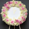 Round floral clock covered in pink and white roses and orchids