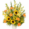 Bouquet of yellow flowers and orange roses in a white vase