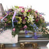 Mother&rsquo;s Garden is a flowing, half-couch, garden-style casket spray designed to rest