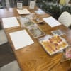 Craft supplies and framed floral pieces arranged on a wooden table