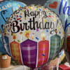 Birthday balloons with candles and confetti