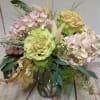Pastel arrangement of green roses and pink hydrangeas in a clear glass vase