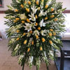 Large standing floral spray with white lilies and yellow roses