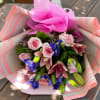 Pink and blue mixed bouquet wrapped in pink paper