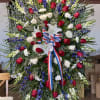 Large standing floral spray with red and white roses and white lilies