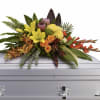 Vivid yellow lilies and bright orange roses meet coral-orange orchid sprays and