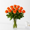 Orange roses arranged in a clear glass vase