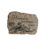 Decorative stone plaque with a bird and flowers and the words 
