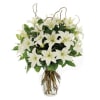 This graceful arrangement of white Asiatic lilies in a classic urn container