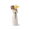 Figurine of a child holding yellow calla lilies