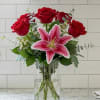 A simply elegant arrangement with 6 red roses and a pink or