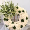 A large wreath of cream  roses creates an immediate sense of
