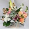 Pink and blush roses meet crisp white lilies in a soft, romantic