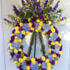 Large floral wreath with yellow and purple roses and blue hydrangeas
