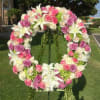 Large floral wreath of pink and white roses with white lilies