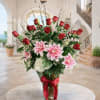Tall vase arrangement with red roses and pink lilies