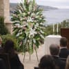 Tall wedding floral arrangement with pink and white flowers on an easel