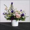 A garden-like arrangement with roses, campanula, stock, veronica, scabiosa, delphinium, gypsy dianthus