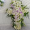 White floral cross-shaped arrangement with pale purple accents