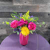 Pink roses and a yellow chrysanthemum in a pink vase