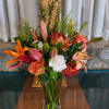 Mixed bouquet of lilies and roses in a clear glass vase