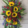 Standing floral spray with sunflowers and red roses