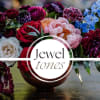Mixed bouquet of roses, peonies, and blue flowers in a vase