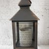 Wooden lantern with a memorial quote on the glass front