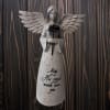 Glittery angel figurine holding a rose with a memorial message