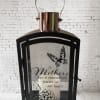 Black lantern with a candle and a Mother's Day memorial message