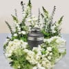 This arrangement has snap dragons, spray roses, hydrangeas, green buttons, daisies, Queen