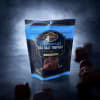 Bag of dark chocolate sea salt truffles with pieces scattered around