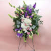 This arrangement has stock, lilies, bells of Ireland, hydrangea, spray roses, roses