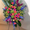 This arrangement has carnations, hydrangeas, Solidago, stock, Delphinium, Gerber daisies, aspidistra leaves