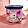 Pink floral scented candle in a black-lidded jar