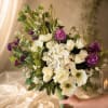A concentrated cloud of crisp white blooms-hydrangeas and anemone-like flowers-forms the heart