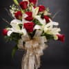 A beautiful one sided red rose arrangement with white cala lilies, greenery