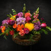 Lively pinks, purples, oranges and sunny yellows burst from a rustic woven