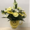 A cheerful arrangement in a smiley container!  Filled with yellow and