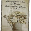 Decorative wall hanging with a watering can of white flowers and a memorial quote