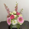 Pink gerberas and white roses in a low square vase