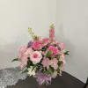 Pink rose bouquet with alstroemeria in a glass vase tied with ribbon