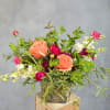 Mixed bouquet of peach and pink roses in a glass vase