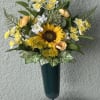 Yellow and white floral arrangement in a tall dark vase