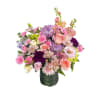 A dreamy pastel arrangement designed in a modern green glass vase. Featuring