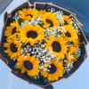 A ring of bold yellow sunflowers with dark centers creates an immediate
